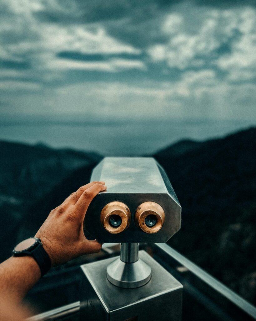 Explore the scenic views of Küçukkuyu, Türkiye through a pair of binoculars at a beautiful viewpoint.